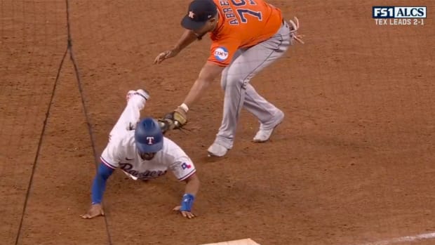 Jose Abreu tags out Marcus Semien by the batting glove in his back pocket during Astros vs. Rangers ALCS Game 4.